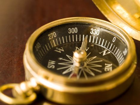 Brass Compass on an old cherrywood table