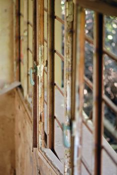 Rusty window frame in decaying house. Selective focus.