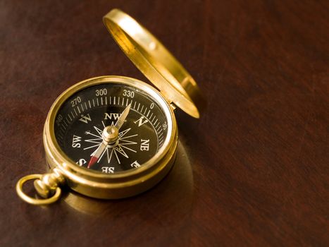 Brass Compass on an old cherrywood table