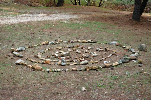 Spiral shape made from stones in a forest.
