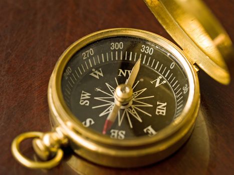 Brass Compass on an old cherrywood table