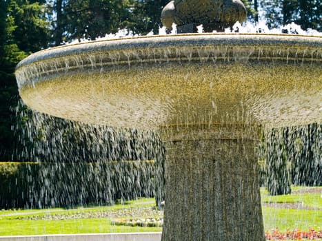 An Outdoor Park Fountain Spraying Water on a Sunny Day