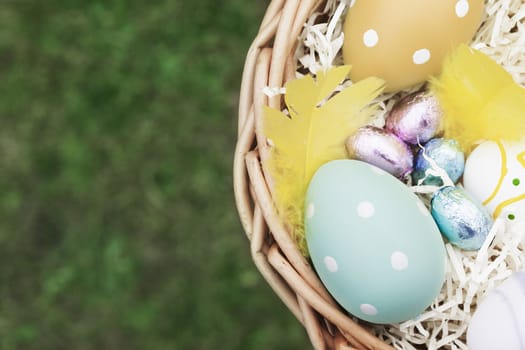 Decorated eggs and candy in Easter Basket, with copy space.