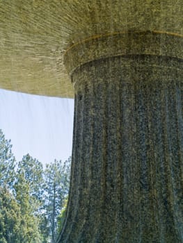 An Outdoor Park Fountain Spraying Water on a Sunny Day