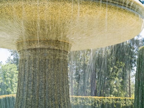 An Outdoor Park Fountain Spraying Water on a Sunny Day