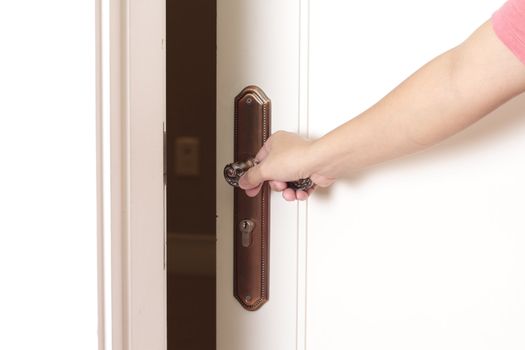 Opening the door with hand on the doorknob 