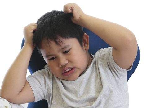 worried boy scratching his head in a white background
