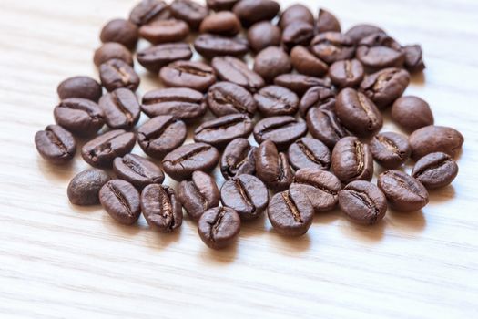 coffee beans on white wooden background