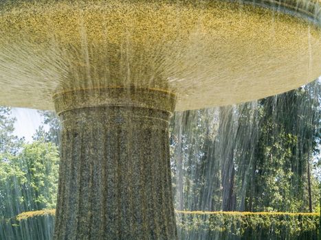 An Outdoor Park Fountain Spraying Water on a Sunny Day