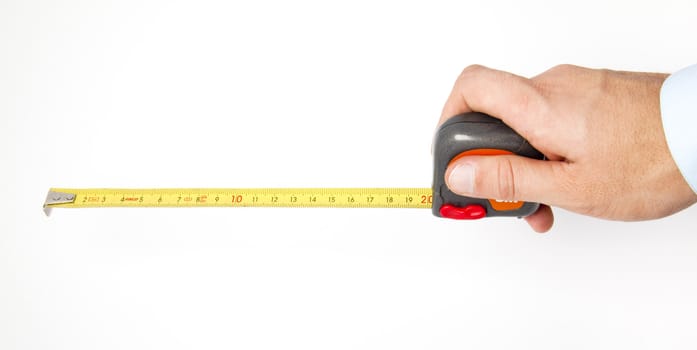 Hand holding a measuring roulette, isolated on white background