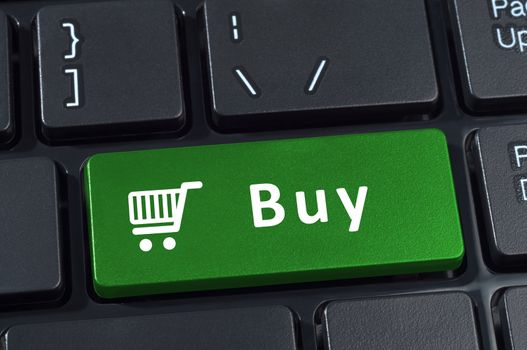 Buy button computer keyboard with trolley icon. Internet concept of consumerism and e-commerce.