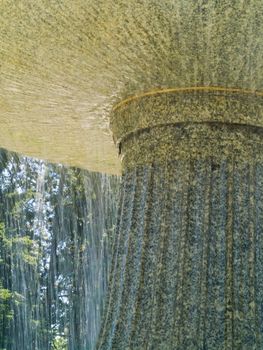 An Outdoor Park Fountain Spraying Water on a Sunny Day