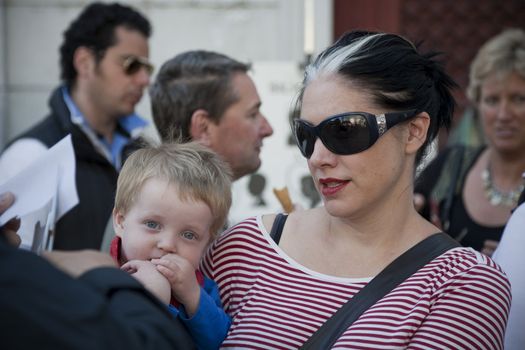 MOTHER AND LITTLE BOY, PARIS, FRANCE - SEPTEMBER 21, 2011: Crowd of tourists at Place du Tertre, Montmartre - Paris.