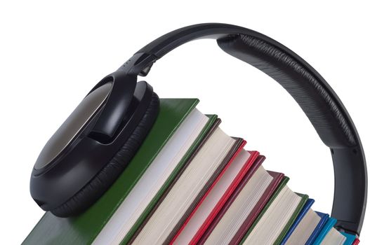Headphones on books close up isolated white background. Concept e-learning and listening audiobooks.