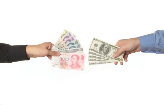 Hands holding yuan and dollar bills isolated