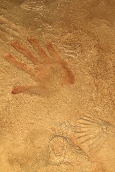 Red hand print on stone background or texture