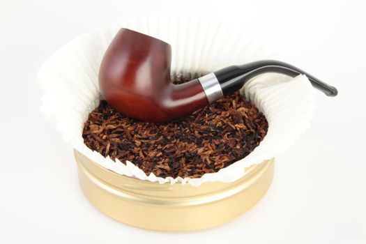 Wooden smoking pipe and tobacco isolated on white