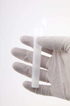 Hand holding medical tube isolated on white