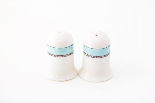 Closeup photograph of small silver and glass salt and pepper cellars