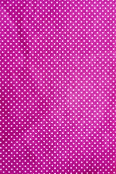 wrinkled purple cloth with a white dot