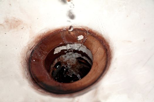 Waterdrops falling into vintage sink for site