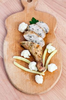 Grilled barbecue chicken quarters on a cutting board