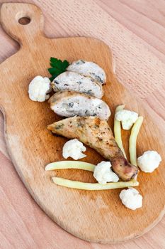 Grilled barbecue chicken quarters on a cutting board