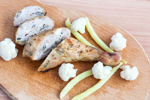 Grilled barbecue chicken quarters on a cutting board