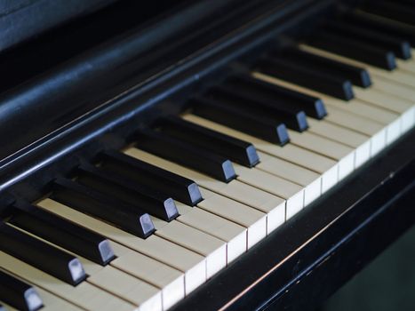 Piano keys of a very well loved and often played piano showing some wear and cracking.