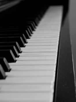 Piano keys of a very well loved and often played piano 