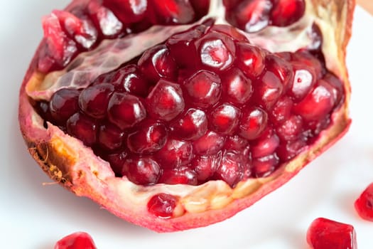 The cut pomegranate and grains on a plate