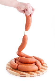 hand holding sausages isolated on white background