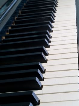 Piano keys of a very well loved and often played piano 