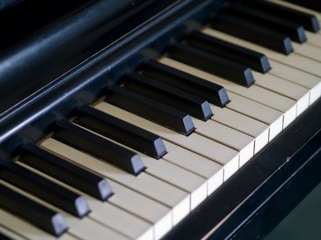 Piano keys of a very well loved and often played piano 