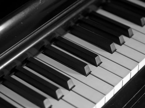 Piano keys of a very well loved and often played piano in monochrome Black and Whit