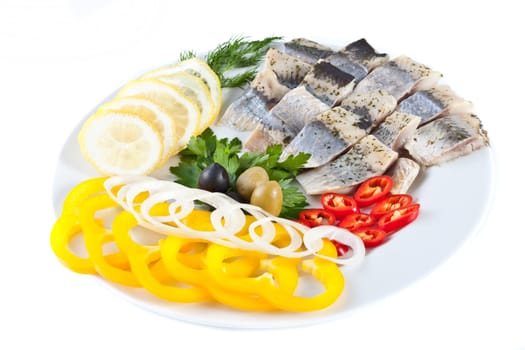 fish on plate with vegetables isolated on white