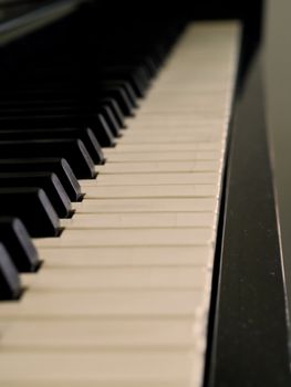 Piano keys of a very well loved and often played piano in Sepia