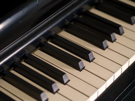 Piano keys of a very well loved and often played piano in Sepia