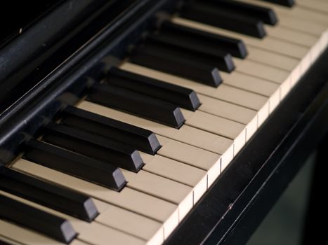 Piano keys of a very well loved and often played piano in Sepia