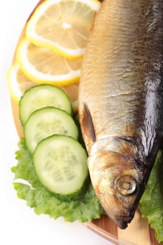 fish with lemon and vegetables close up