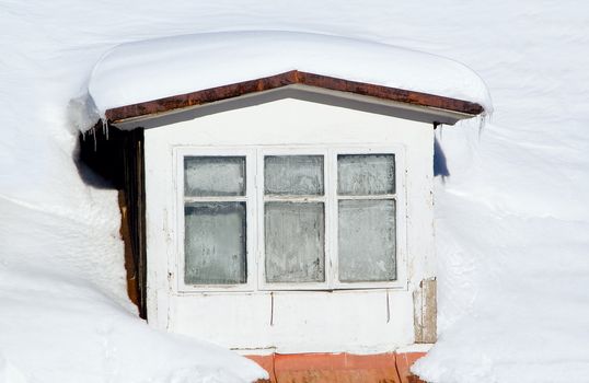 Old window on abandoned mountain house in winter time