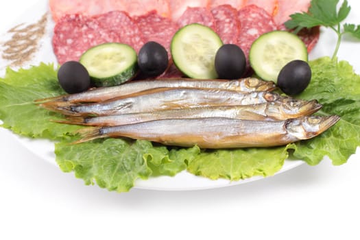 kipper fish on composition with vegetables close up