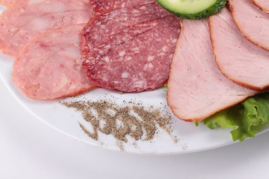 various sliced sausages with vegetables close up