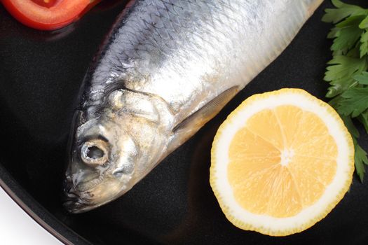 fish on pan with lemon close up