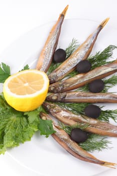 kipper fish on composition with vegetables close up