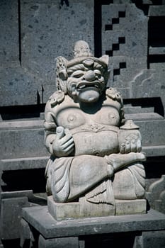 Traditional Balinese god statue in front of the temple