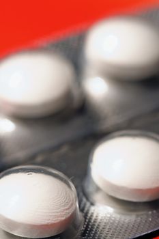 Macro of pills on orange background