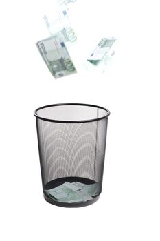 money flying into the trash isolated on white
