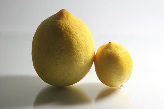 two lemons vertical with dramatic shadows