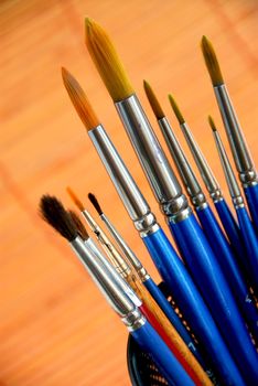 Paintbrushes in a metal mesh holder 